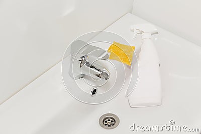 Cleaning the faucet cleaning products. The cleanliness in the house Stock Photo