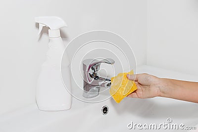 Cleaning the faucet cleaning products. The cleanliness in the house Stock Photo