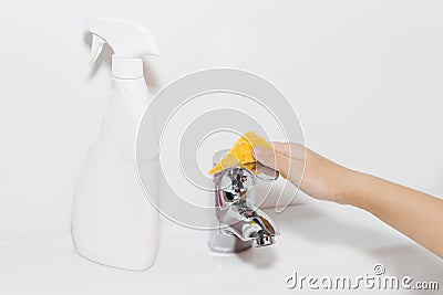 Cleaning the faucet cleaning products. The cleanliness in the house Stock Photo