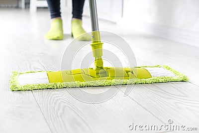 Cleaning floors with a mop Stock Photo