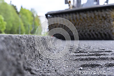 Cleaning of garbage from the road. a rotating mechanical machine brush Stock Photo