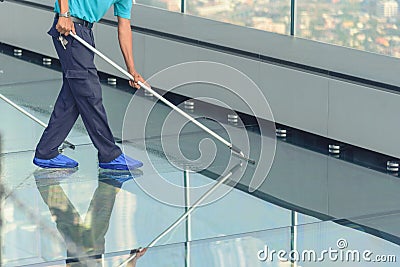 Cleaning glass floor of high building Stock Photo