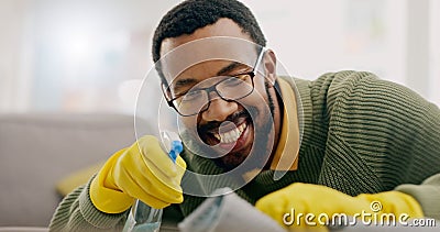 Cleaning, happy and man with spray for furniture in living room for hygiene, housework and maintenance in home Stock Photo