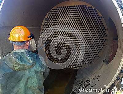 Cleaning of heat exchange equipment with a high-pressure hydraulic unit. Washing the shell and tube heat exchanger Editorial Stock Photo