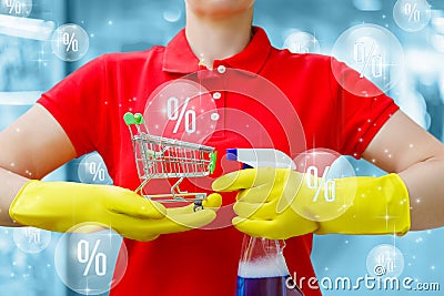 Cleaning lady holds a shopping basket and spray in her hands against the background of percents flying in a bubbles Stock Photo