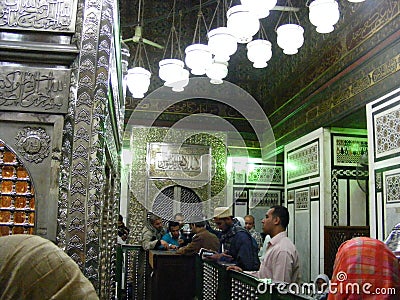 people praying inside mosque holy grave of sayda zainab in egypt cairo Editorial Stock Photo