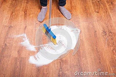 Cleaning person sweeping the wooden floor Stock Photo