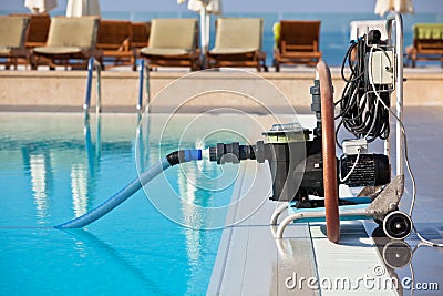 Cleaning pump working with a swimming pool Stock Photo