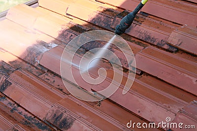 Cleaning a roof with high pressure cleaner Stock Photo