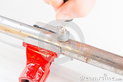 Cleaning of rusty pipe with rotary multi tool Stock Photo