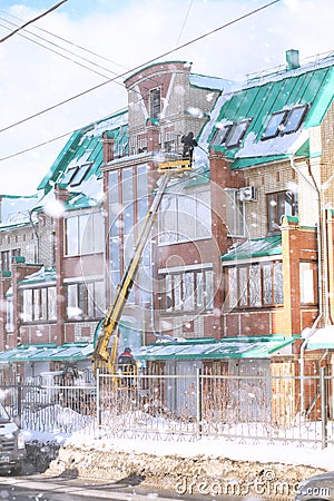 The cleaning service cleans the snow from the roof of the house. Editorial Stock Photo