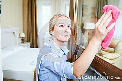 Cleaning service. hotel staff clean glass door from dust Stock Photo