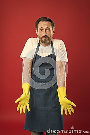 Cleaning service and household duty. Lot of work. Gardening concept. Man in apron with gloves cleaning agent. Cleaning Stock Photo