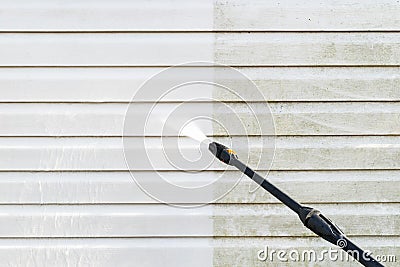 Cleaning service washing building facade with pressure water. Cleaning dirty wall with high pressure water jet. Power washing the Stock Photo