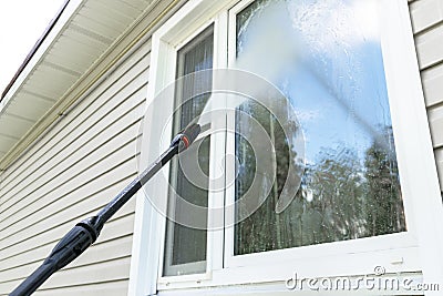 Cleaning service washing building facade and window with pressure water. Cleaning dirty wall with high pressure water jet. Power w Stock Photo