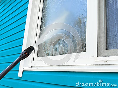 Cleaning service washing building facade and window with pressure water. Cleaning dirty wall with high pressure water jet. Power w Stock Photo