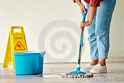 Cleaning, sign and woman mopping floor in office for hygiene, health and wellness. Spring cleaning, service and janitor Stock Photo