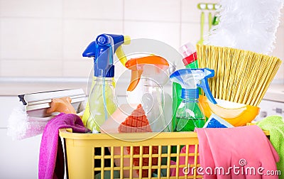 Cleaning supplies in basket in kitchen Stock Photo