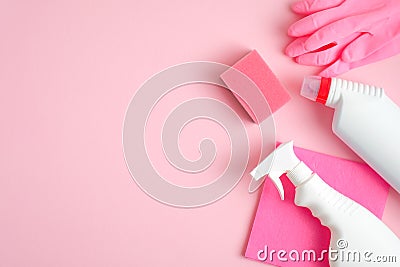 Cleaning supplies on pink background. Top view cleaner spray bottle, rag, sponge, detergent, rubber gloves. House cleaning service Stock Photo