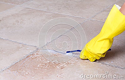 Cleaning tile grout with toothbrush Stock Photo