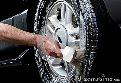 Cleaning tire in a car wash Stock Photo