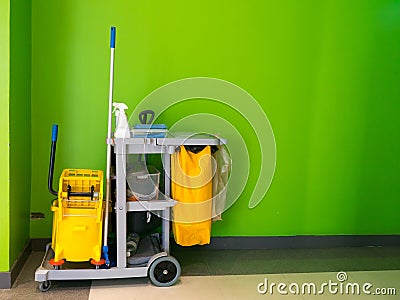 Cleaning tools cart wait for cleaning.Bucket and set of cleaning equipment in the office. janitor service janitorial for your plac Stock Photo