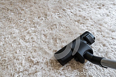 Cleaning white carpet, vacuum cleaner cleaning dust and dirtiness on carpet in living room Stock Photo