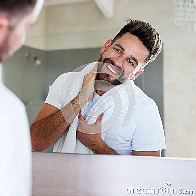 Cleanliness is next to godliness. a handsome young man going through is morning routine in the bathroom. Stock Photo