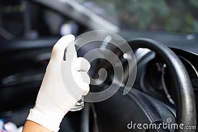 Cleansing car interior and spraying with disinfection liquid for protection from Covid-19 virus disease Stock Photo