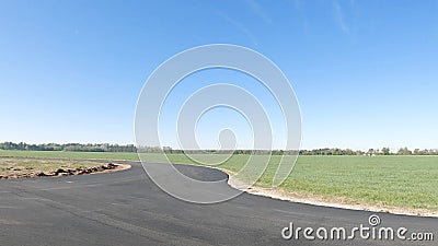 Clear blue sky and distant farmland newly paved road Editorial Stock Photo