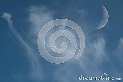 Clear Blue Sky with Whispy Faint Clouds and a sickle Moon Stock Photo