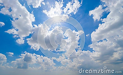 Clear blue sky with white fluffy clouds in summer season at noon time. Abstract nature background Stock Photo