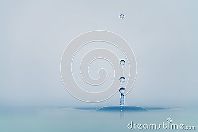 Clear blue water drop with ripple on surface Stock Photo