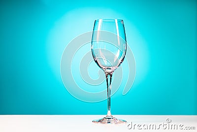 Clear drinking glass isolated on cyan blue background Stock Photo