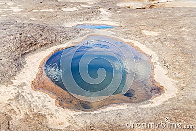 Clear emerald green water inside the hole rock Stock Photo