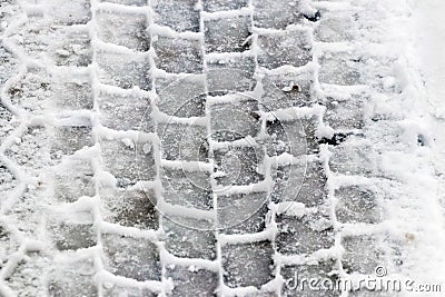 Clear imprint of a car tire on wet snow Stock Photo