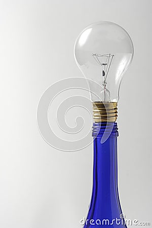 A clear light bulb on blue oil bottle Stock Photo