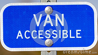 Clear Panorama Blue sign with a Van Accessible text on a parking area for handicapped people Stock Photo