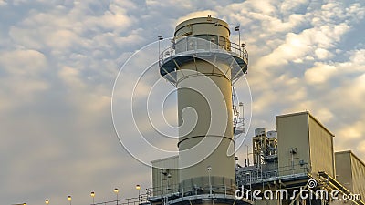 Clear Panorama Power Plant in Utah Valley emitting smoke against sky filled with puffy clouds Stock Photo
