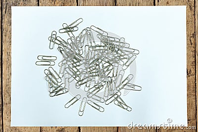 Clear paper and paper clip on wood table Stock Photo