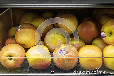 A clear plastic bin filled with apples in the market in Atlanta Georgia Editorial Stock Photo