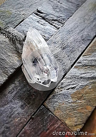 Clear quartz pendant chain silver slate Stock Photo