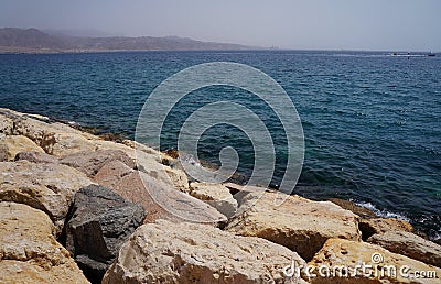 Clear sea water surface, stones and glare Stock Photo