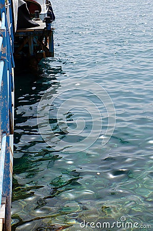 Clear sea water surface, stones and glare Stock Photo