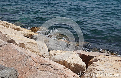 Clear sea water surface, stones and glare Stock Photo