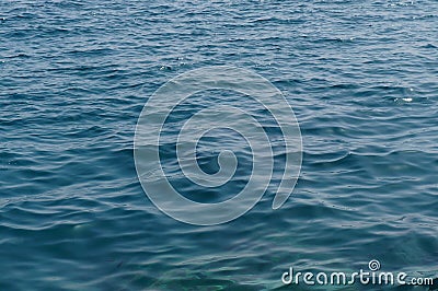 Clear sea water surface, stones and glare Stock Photo