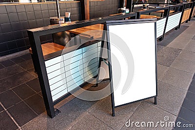 Clear street signage board placed by an outdoor dinning area of a restaurant. Stock Photo