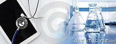 Clear water in flask with stethoscope and computer tablet medical science lab banner background Stock Photo