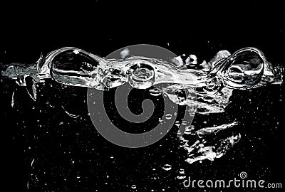 Clear water surface on a black with ripple and bubbles Stock Photo