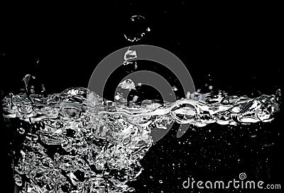 Clear water surface on a black with ripple and bubbles Stock Photo